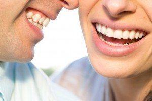 Couple beautiful teeth from dental bonding smiling together.